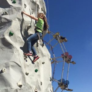 Girl climbing a rock wall