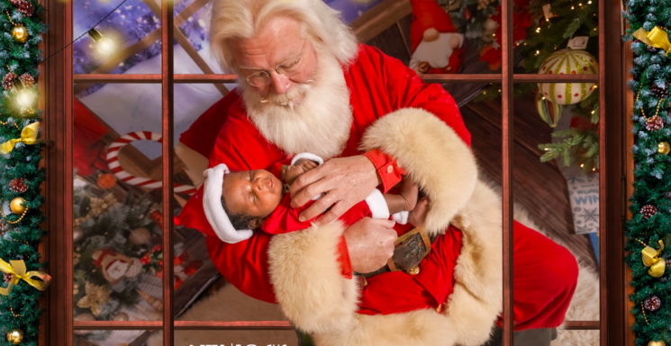 Santa holds small sleeping baby - Santa's Coming to Town