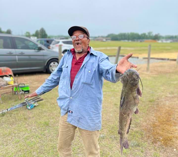 Senior man shows off his winning fish - Fishing Rodeo