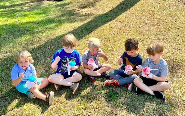 Five Children Sit in a Park Eating Snow Cones Back to School