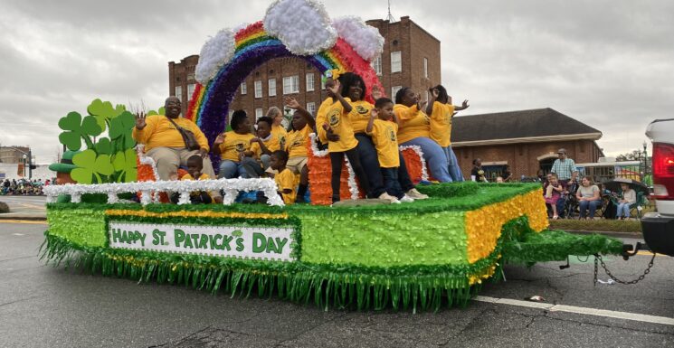 Colorful parade float full of waving children rides down Dublin streets St. Pat's Top 40
